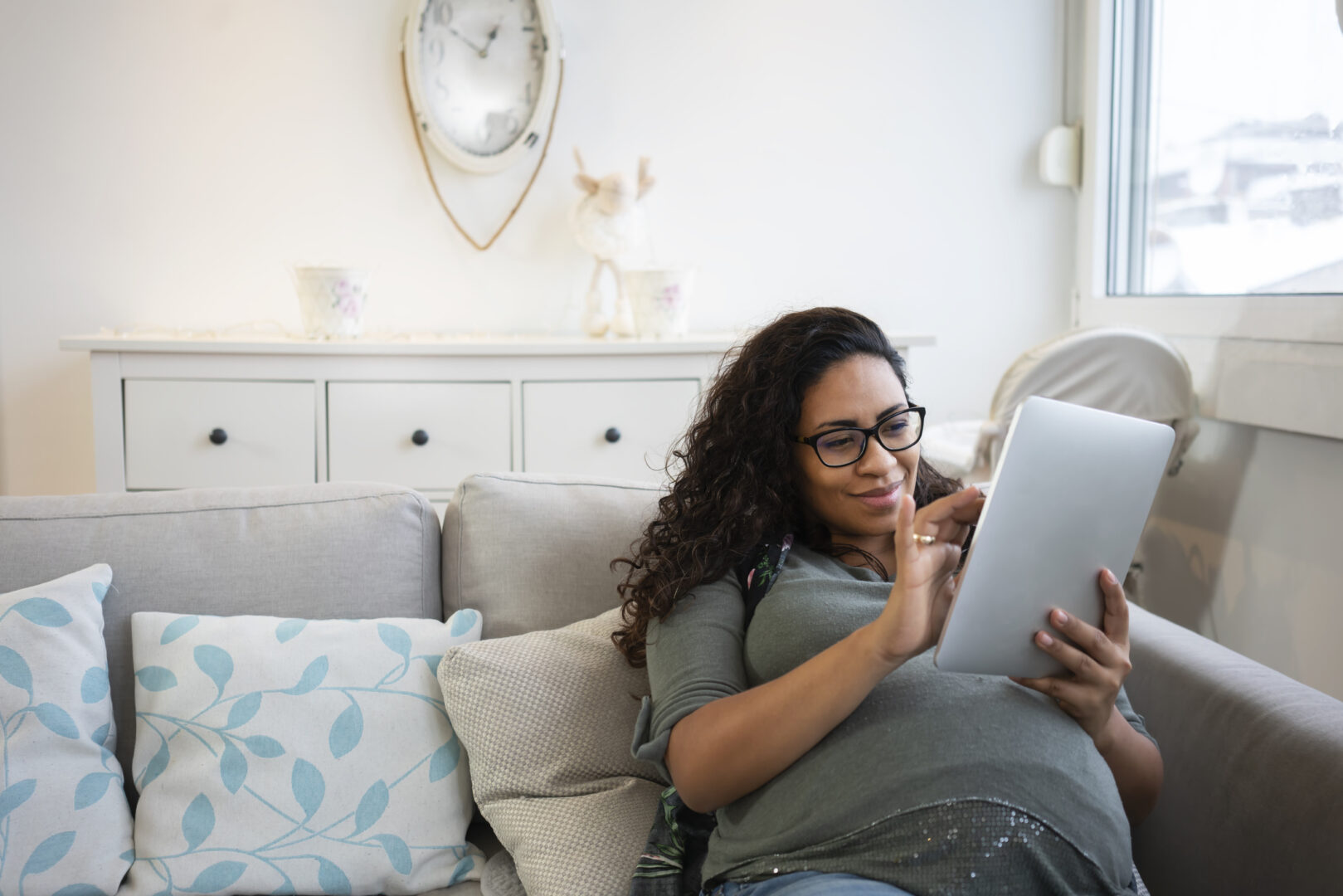 Pregnant woman using technology at home